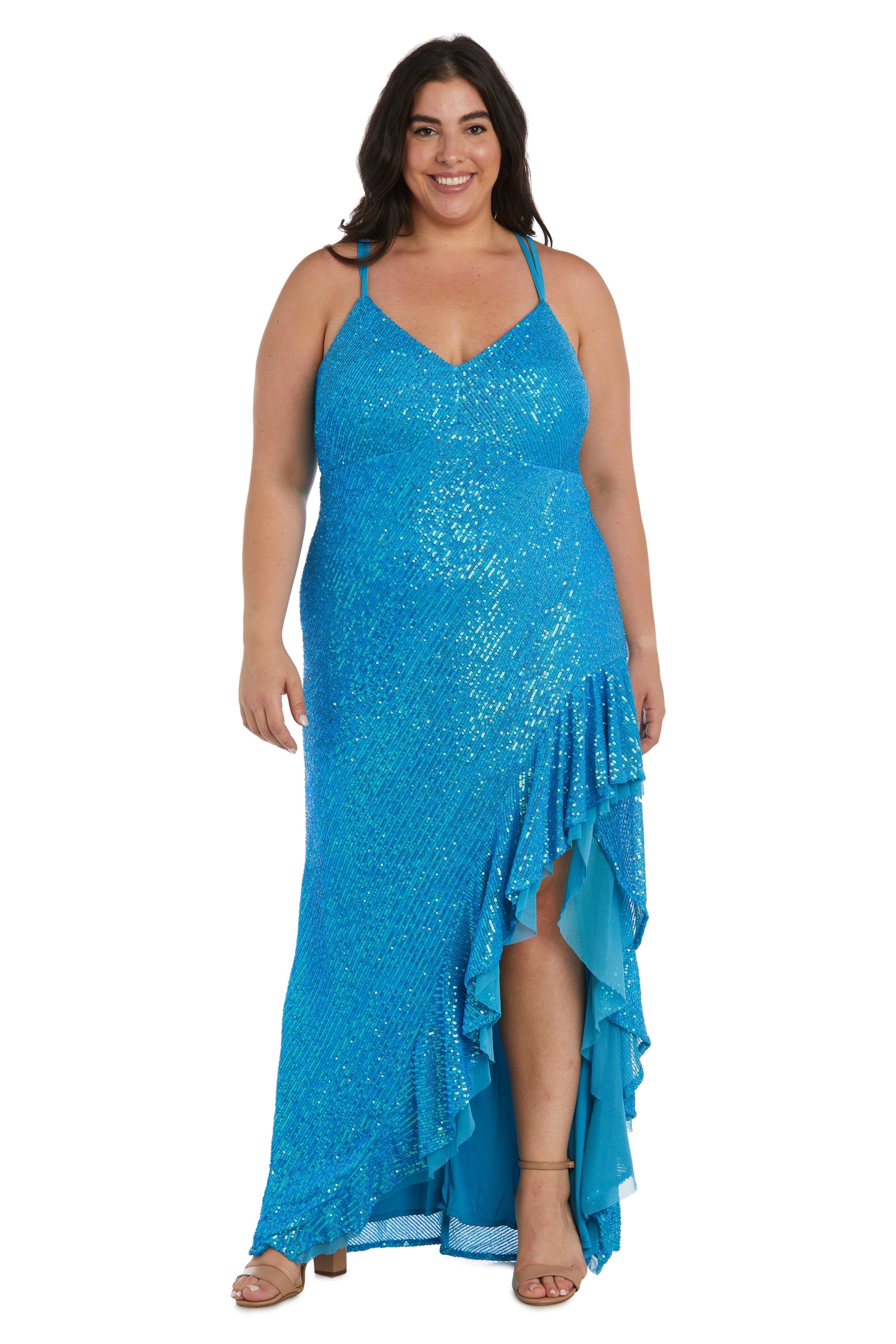 A woman stands and smiles in the Morgan 13029WM, a long plus-size sequin prom dress featuring a sleeveless design, bright blue color, v-neckline, ruffle details, and high-low hem.